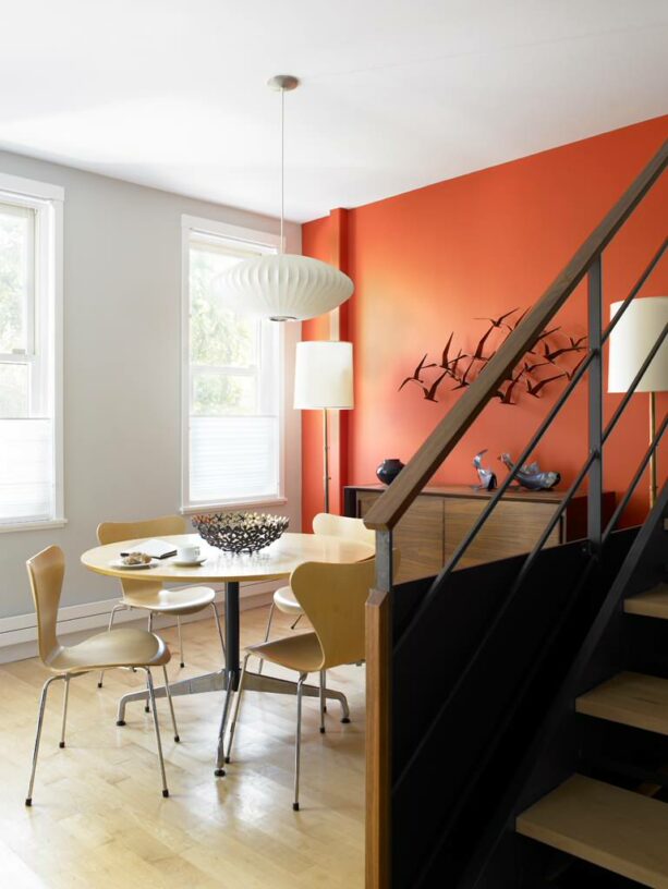 a zestful atmosphere because of the combination of Gray Owl and Tropical Orange in a midcentury dining room