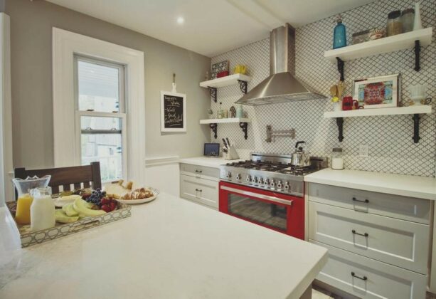 the popping visual from the combination of Gray Owl cabinets and bright red range
